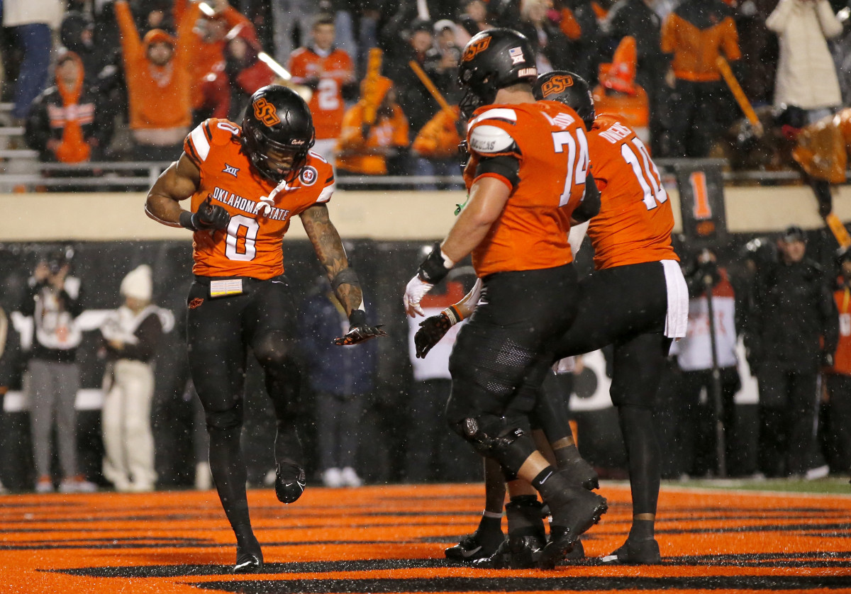 Oklahoma State Cowboys running back Ollie Gordon II strikes the Heisman pose after a touchdown against the BYU Cougars.